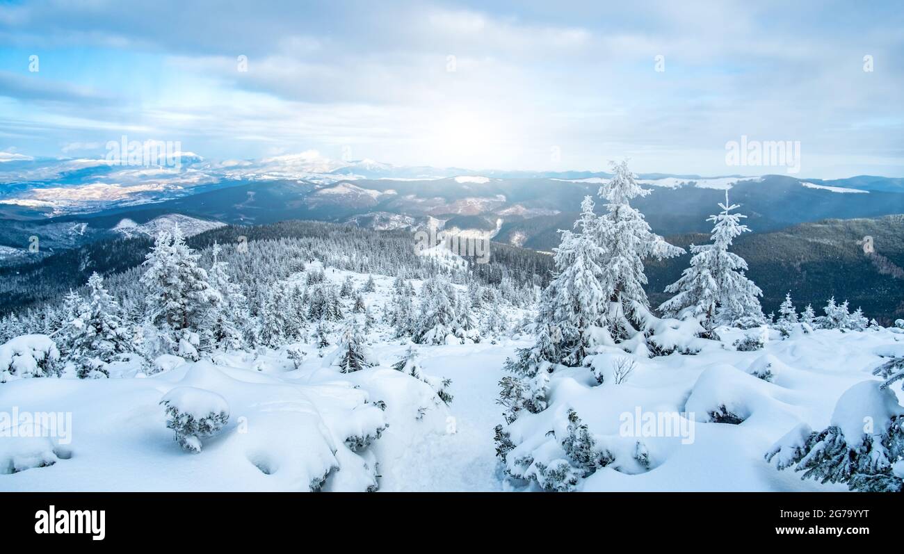 Snowy mountain range under winter sun Stock Photo - Alamy