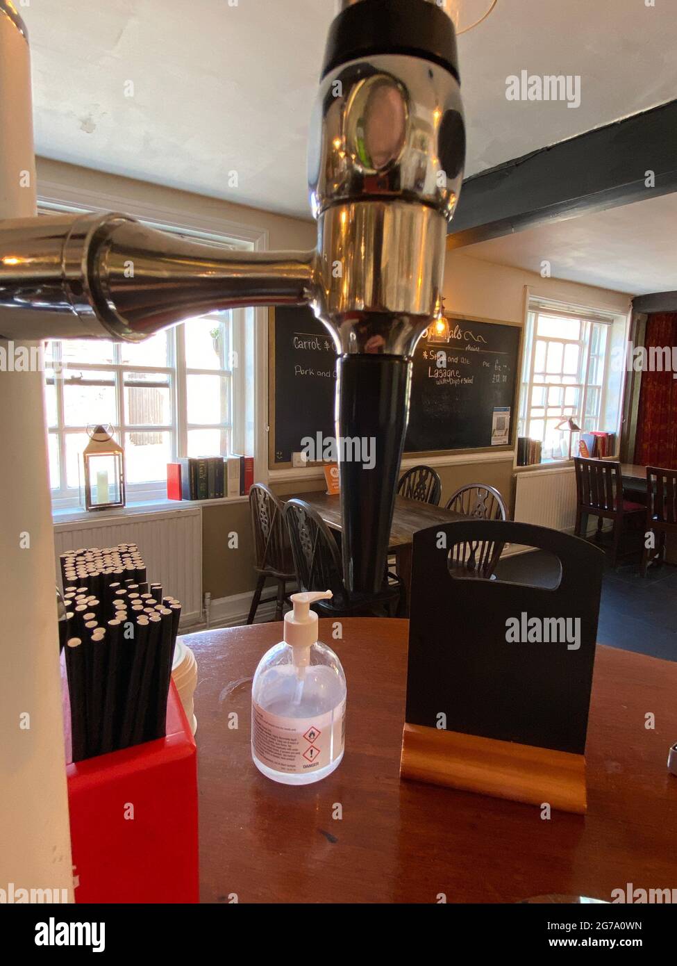 beer taps in pub bar with cleaning spray following covid19 guidelines