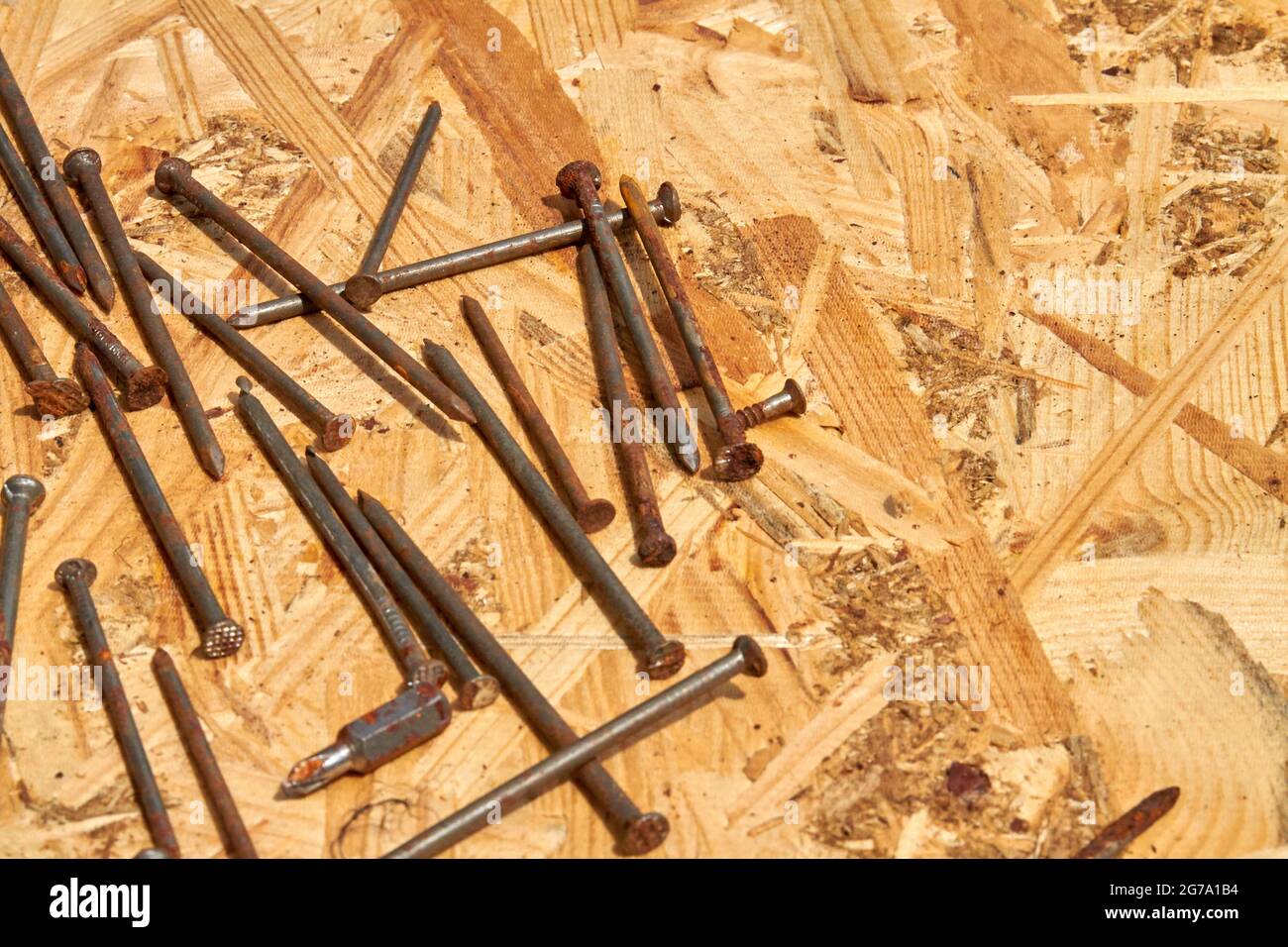 Many metal nails on plywood background flat lay Stock Photo Alamy