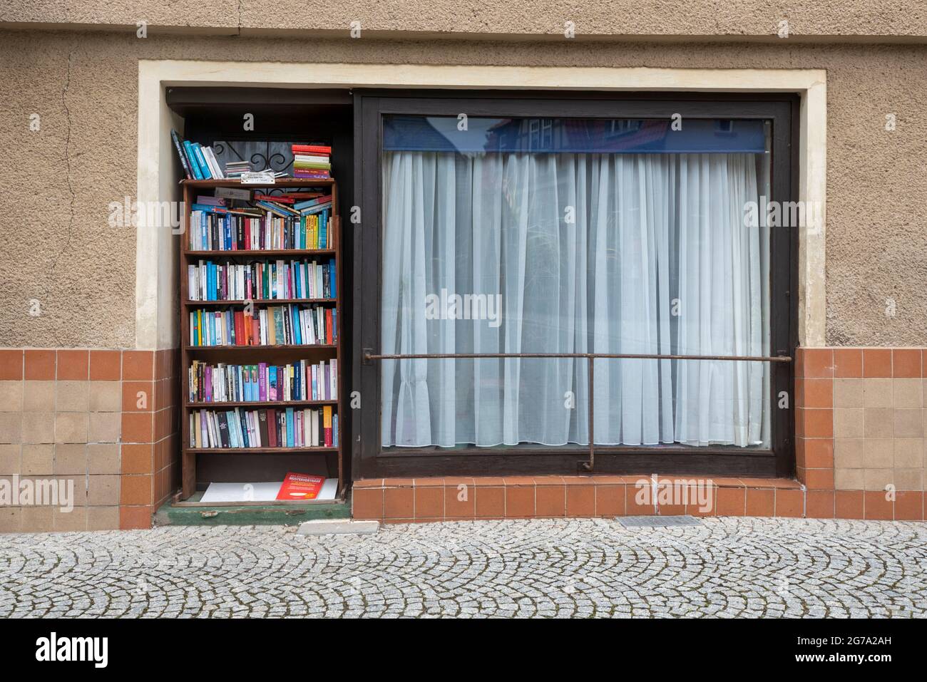 Germany, Saxony-Anhalt, Gernrode, antiquarian books stand on a shelf on a street. Stock Photo