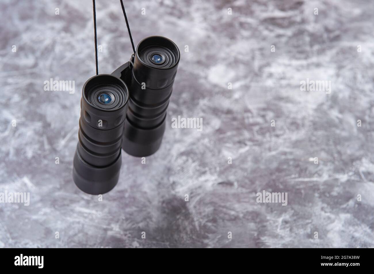 Binoculars on a grey background Stock Photo