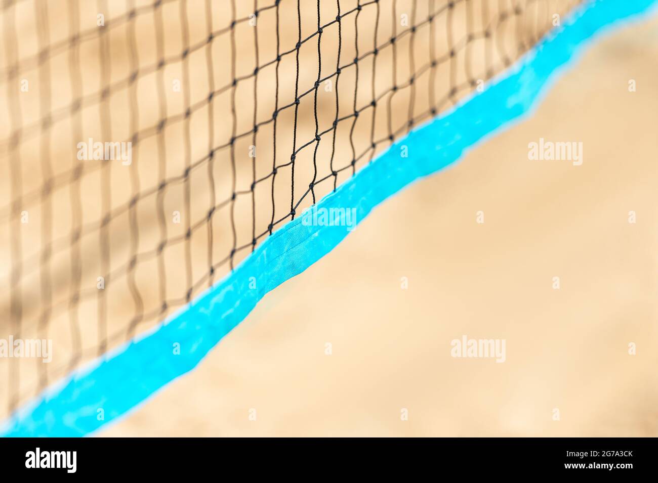 Beach volleyball and beach tennis net on the background of sand. Summer