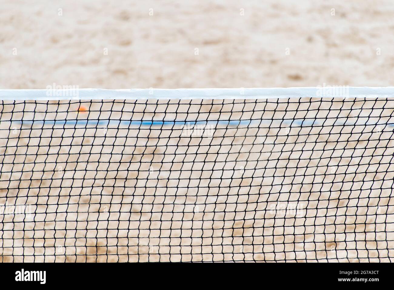Beach volleyball and beach tennis net on the background of sand. Summer
