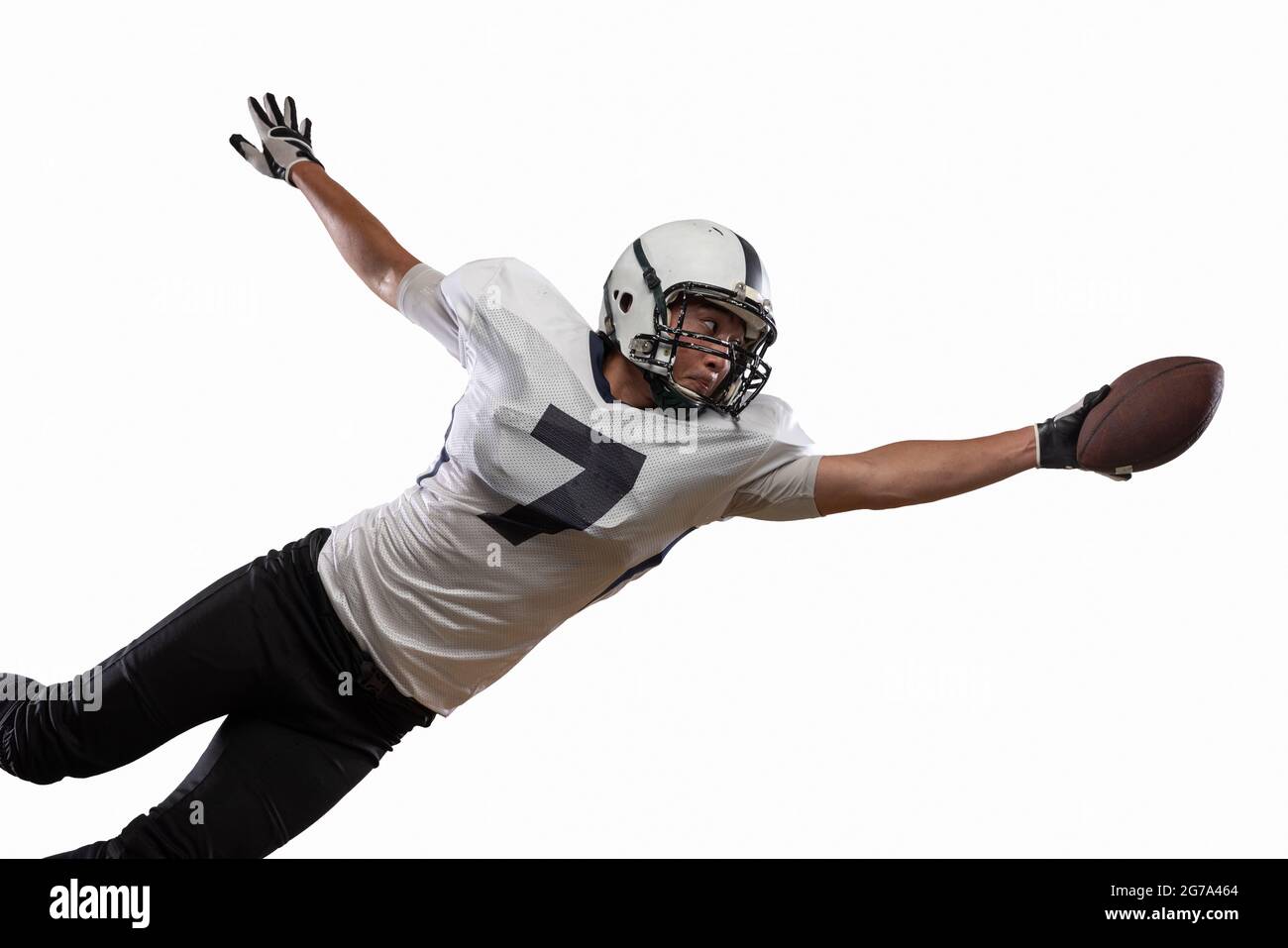 Portrait of American football player catching ball in jump isolated on