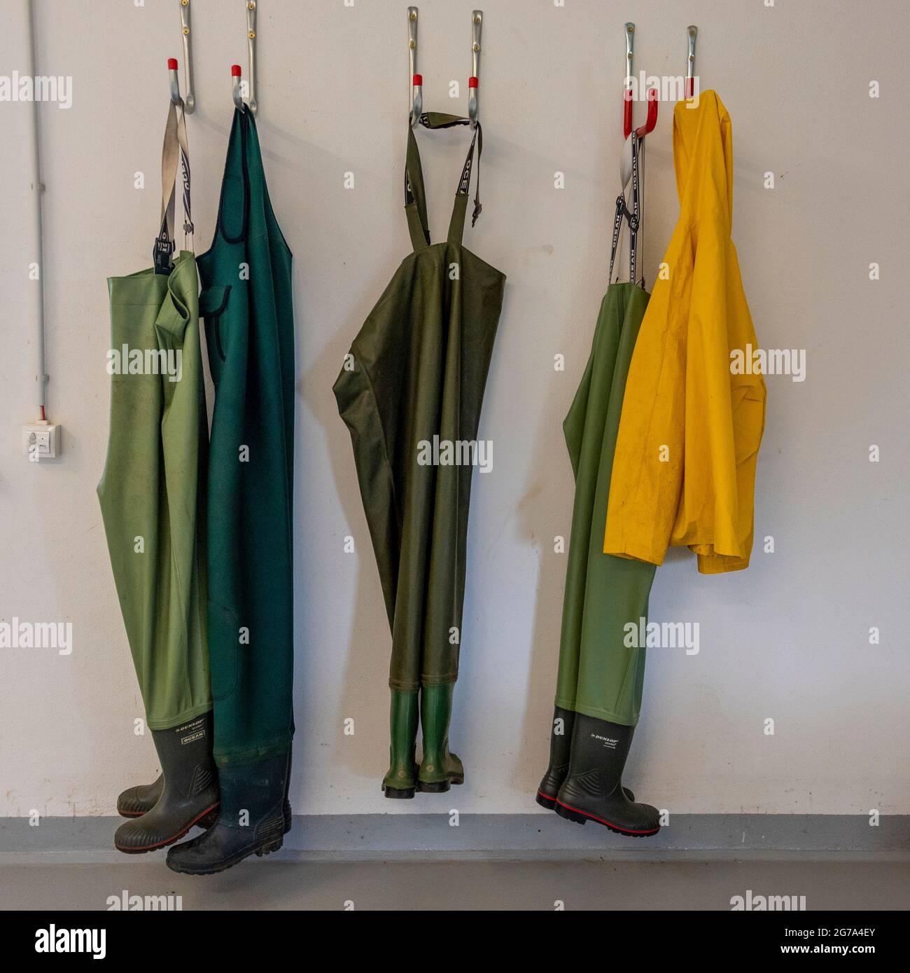 Waders hang on a wall Stock Photo Alamy