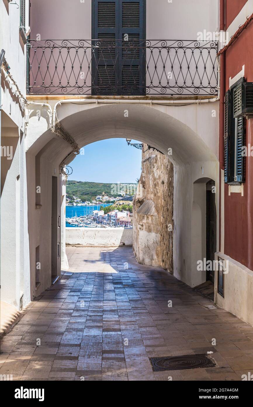 Narrow alley with arch, looking through the harbor, Placa de la Conquesta, Mahon, Mao, Menorca, Spain, Europe Stock Photo