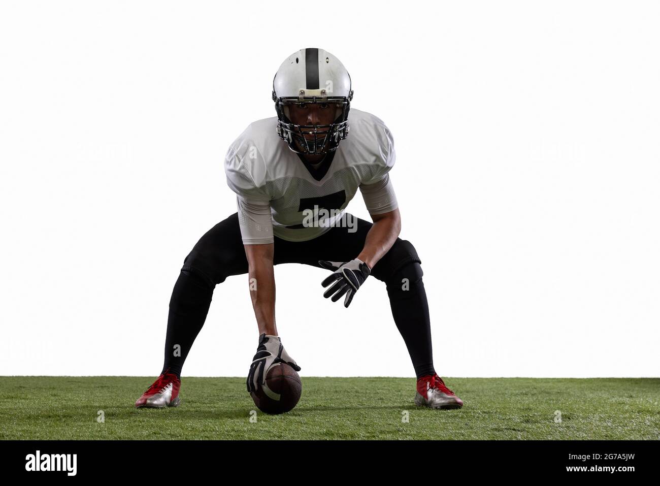 Portrait of American football player training, playing isolated on