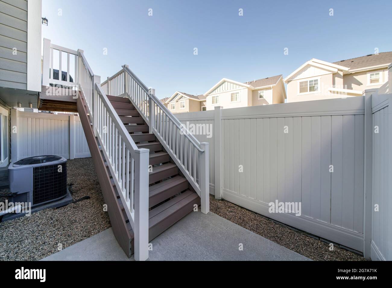 House with heating and cooling system unit and deck stairs outside Stock Photo