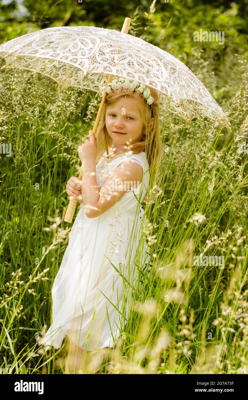 Happy girl holding umbrella hi-res stock photography and images - Alamy
