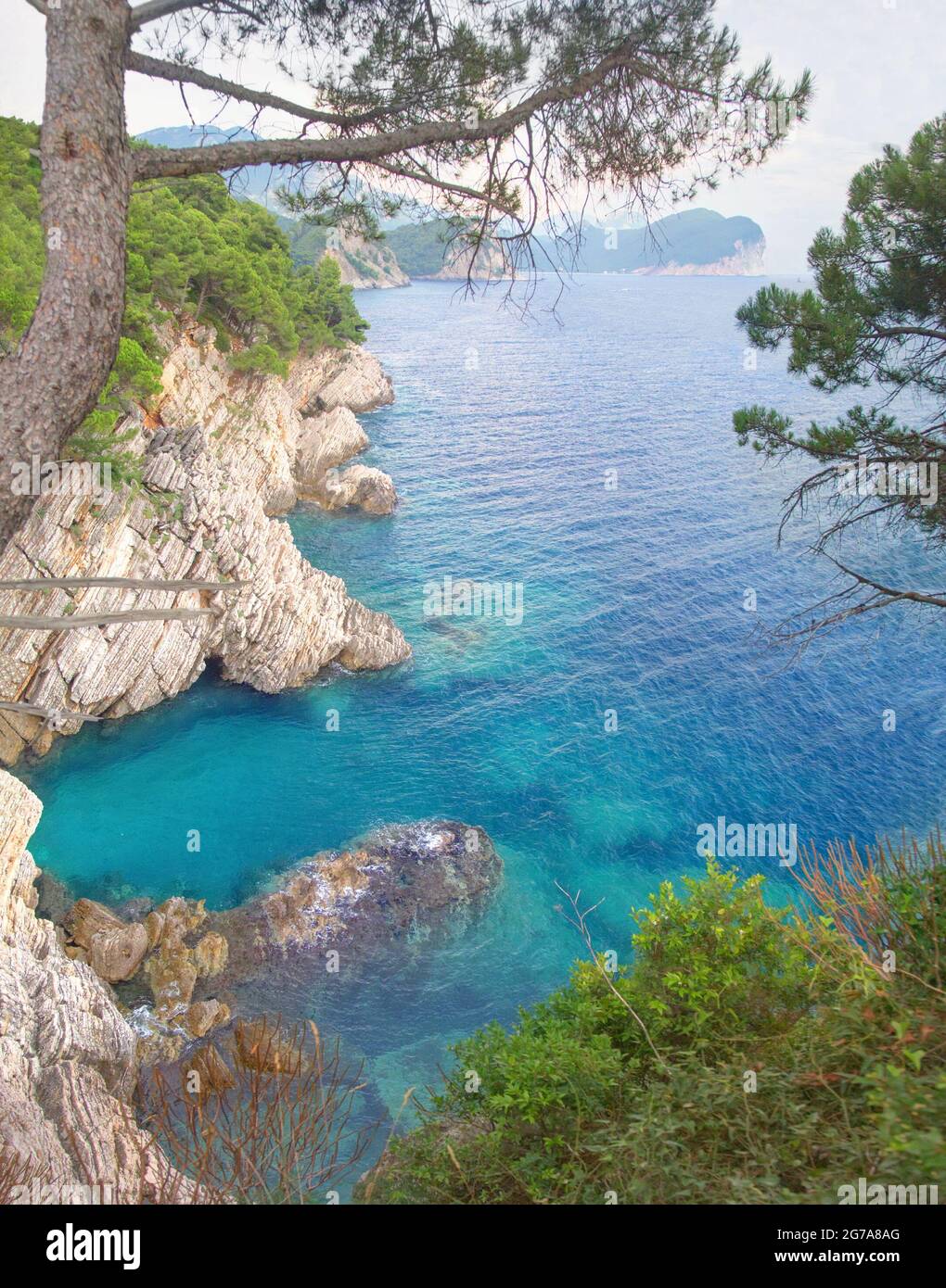 The layered rocks and turquoise sea. Petrovac, Montenegro Stock Photo