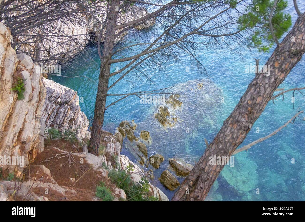 The layered rocks and turquoise sea. Petrovac, Montenegro Stock Photo