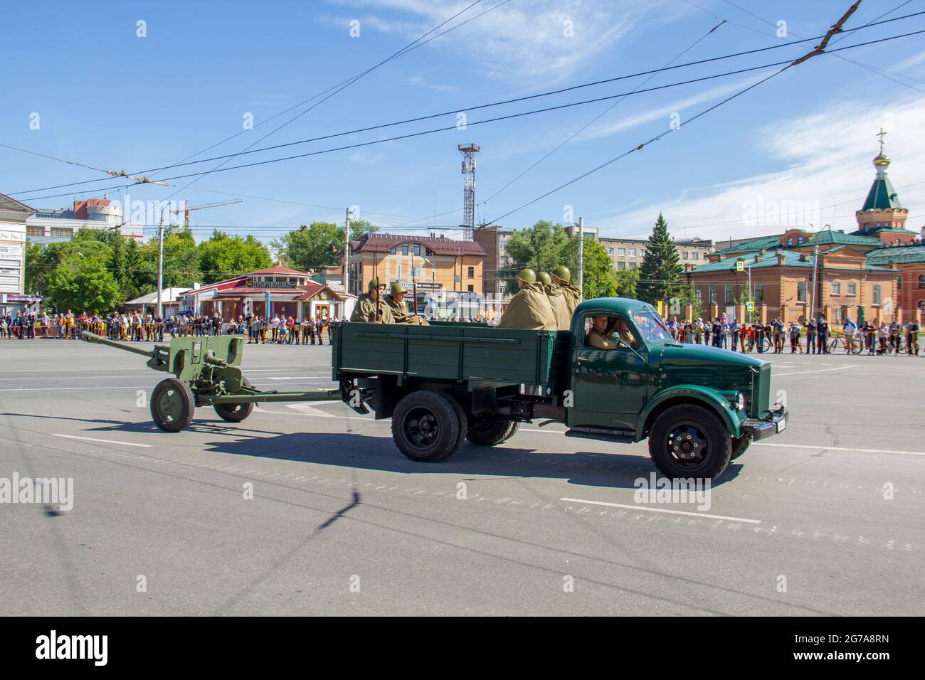 Omsk, Russia. 24 June, 2020. Perfectly restored military vehicle GAZ-51 with soldiers and a light cannon are moving in a festive column. Parade of mil Stock Photo