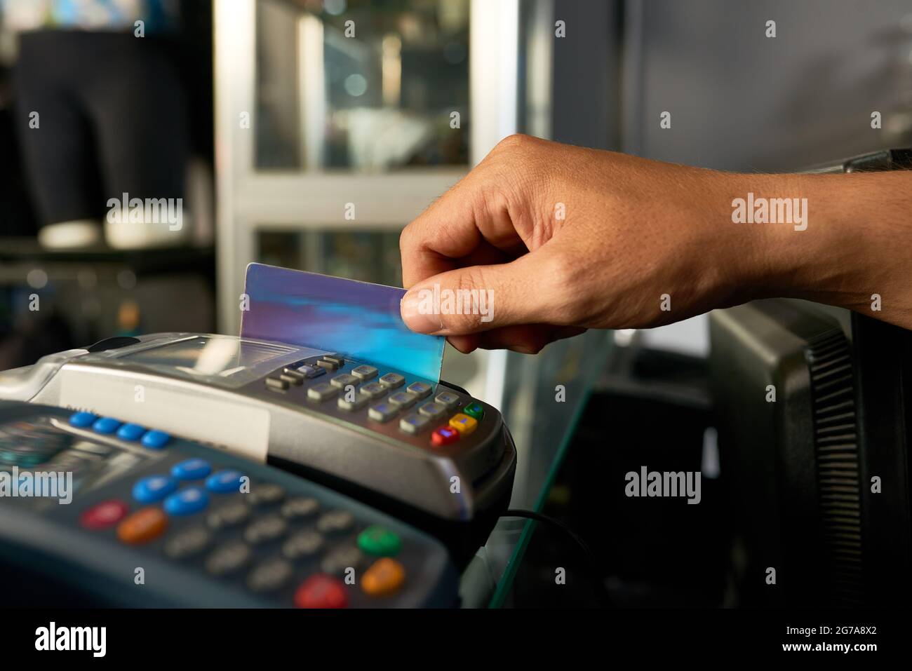 Shop assistant swiping credit card hires stock photography and images