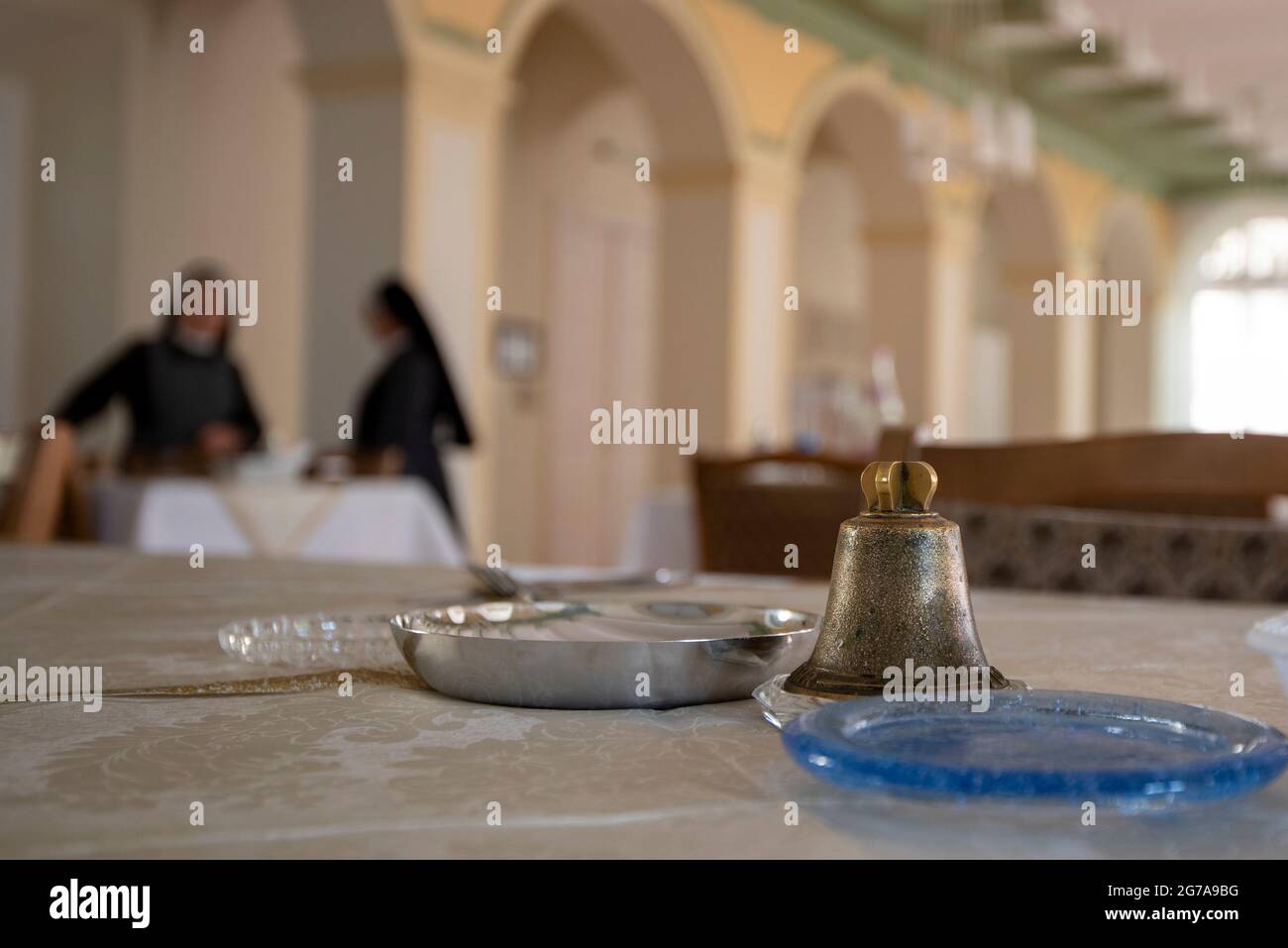 Germany, Saxony-Anhalt, Halle, table bells in the monastery, behind it two nuns, order of Saint Elisabeth Stock Photo