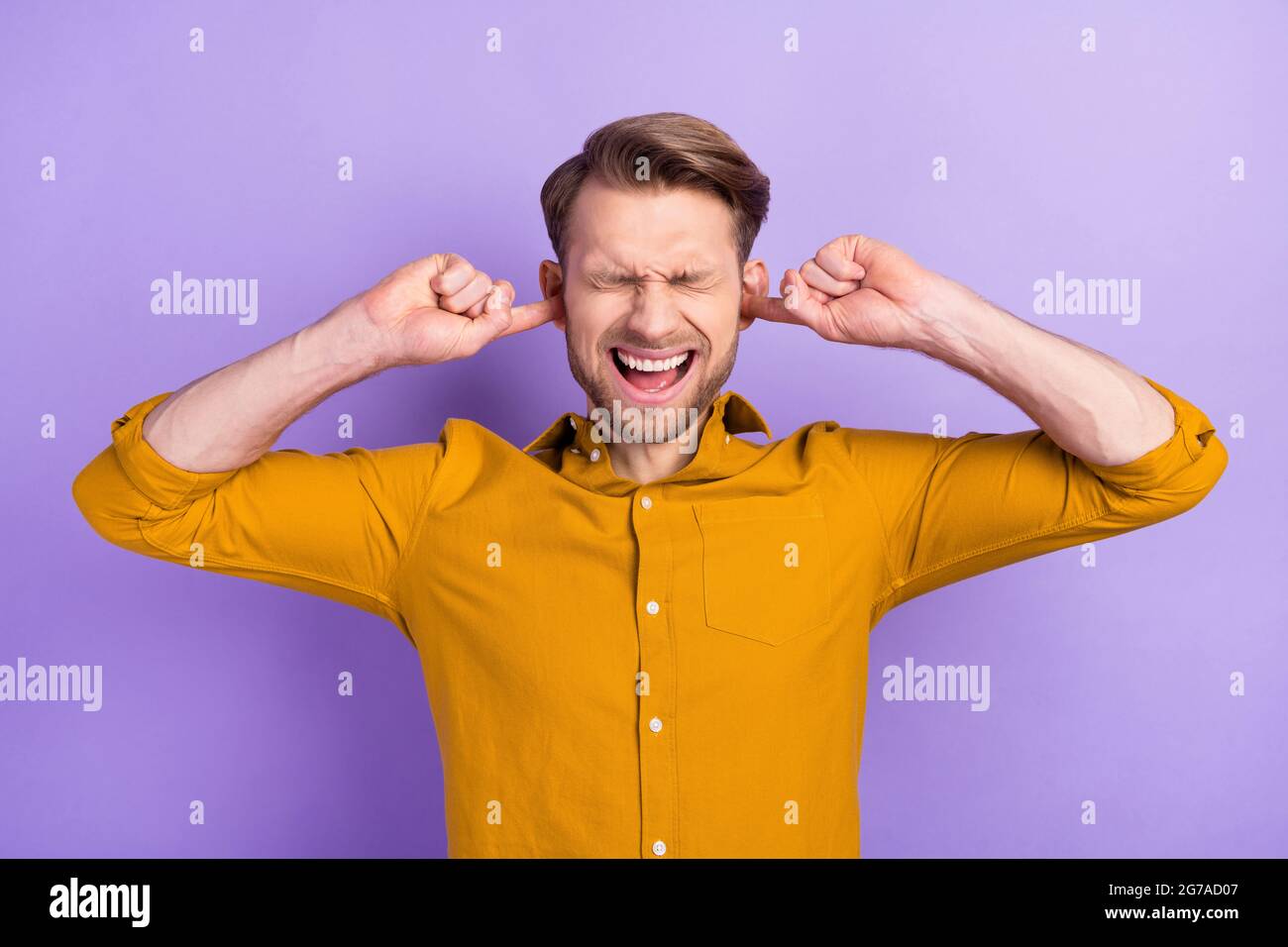 Photo of young man unhappy irritated close ears fingers loud noise ...