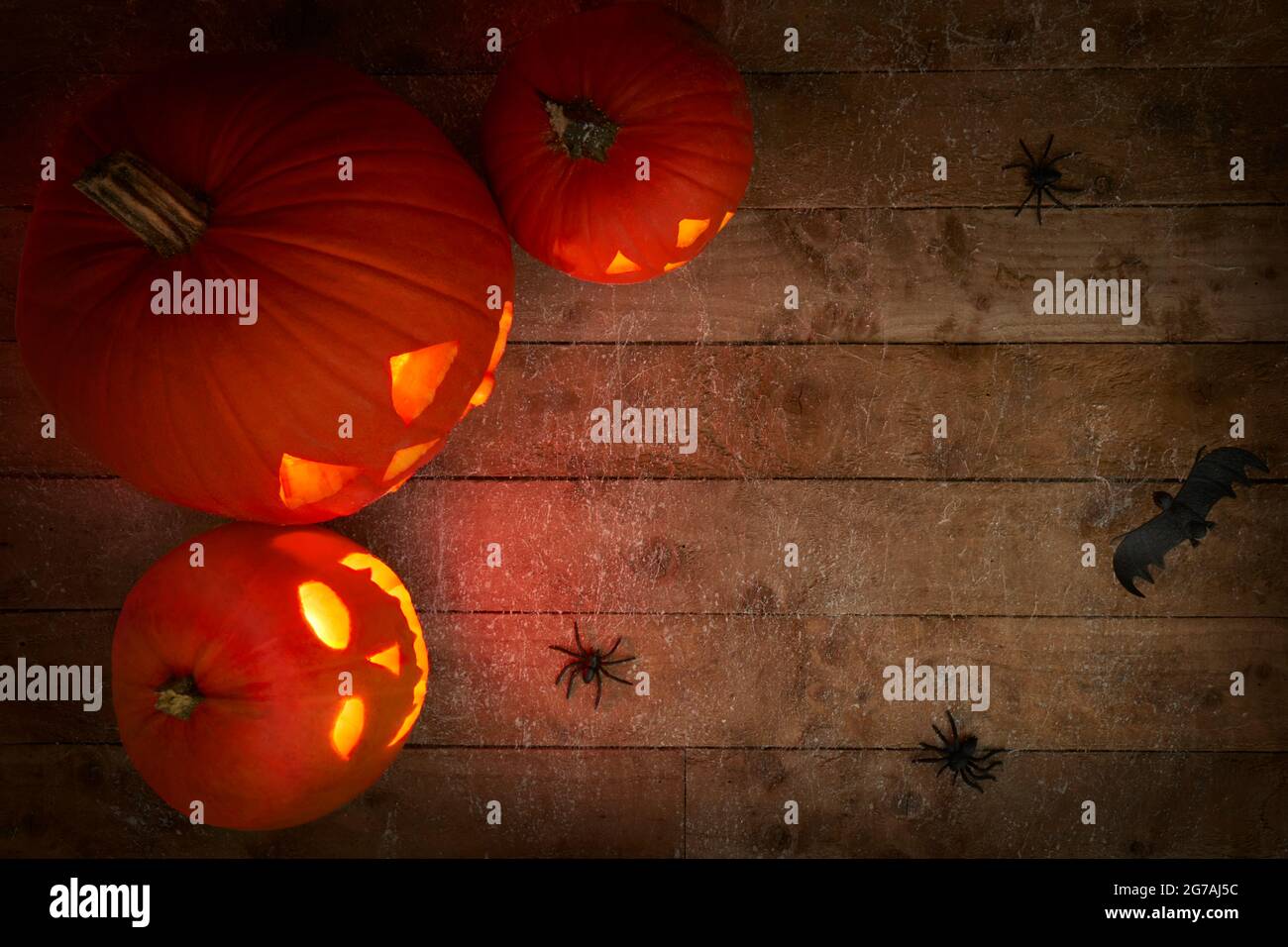 glowing pumpkins on a dark wooden cobweb background Stock Photo - Alamy