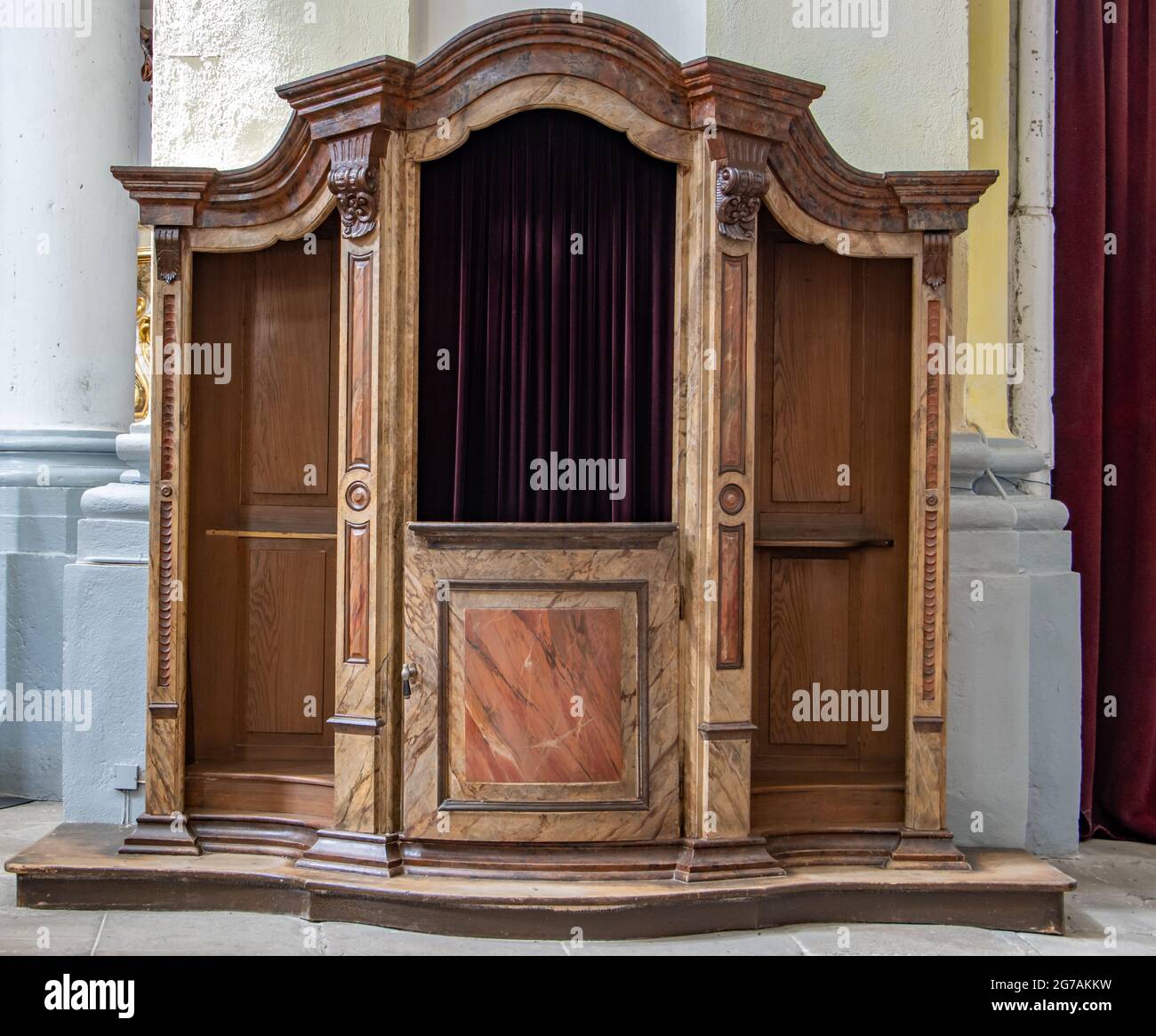 The historical confessional at baroque church. Stock Photo