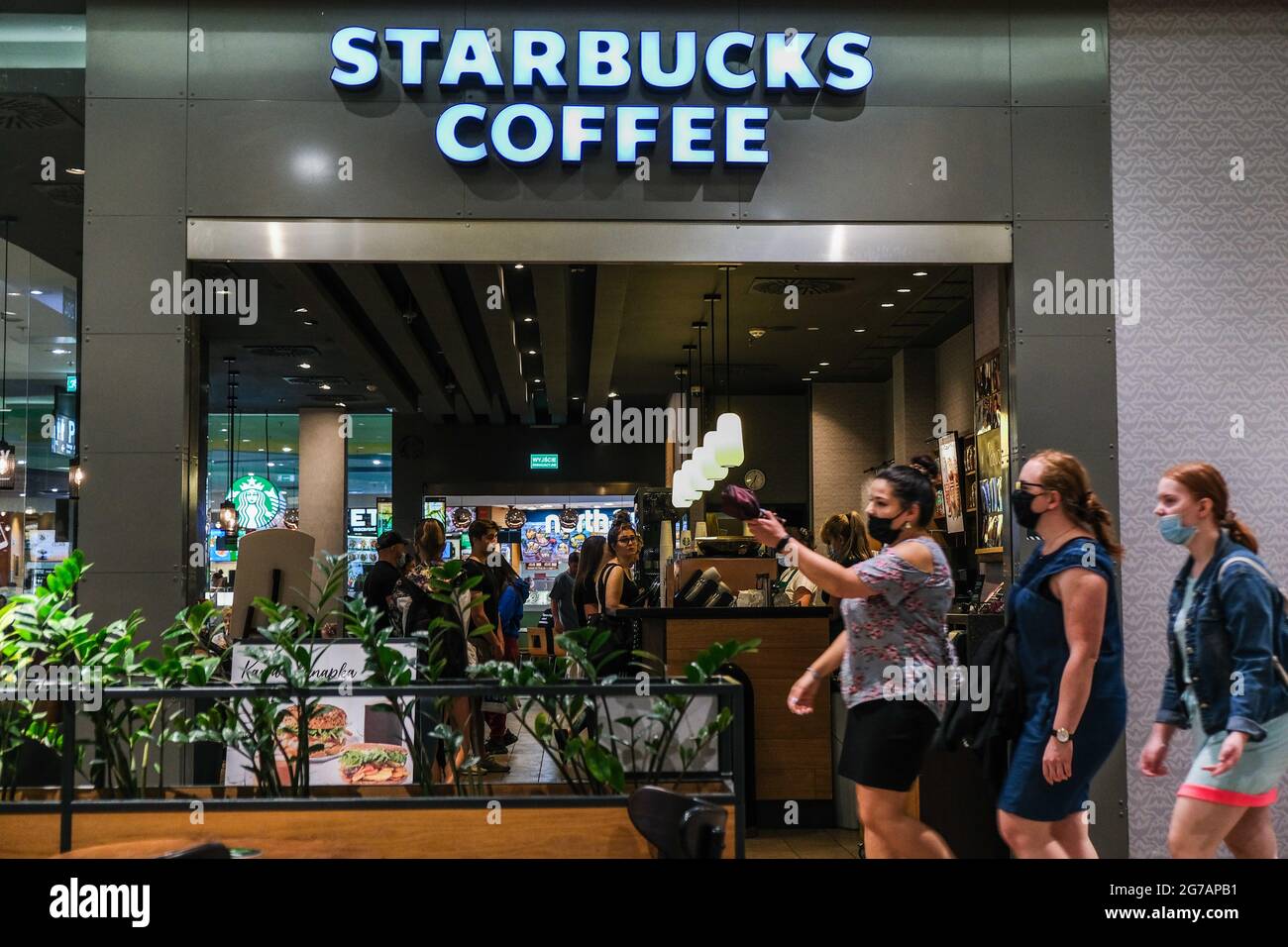 Krakow, Poland. 12th July, 2021. People wearing masks walk past a Starbucks  coffee inside a shopping mall. Credit: Omar Marques/SOPA Images/ZUMA  Wire/Alamy Live News Stock Photo - Alamy