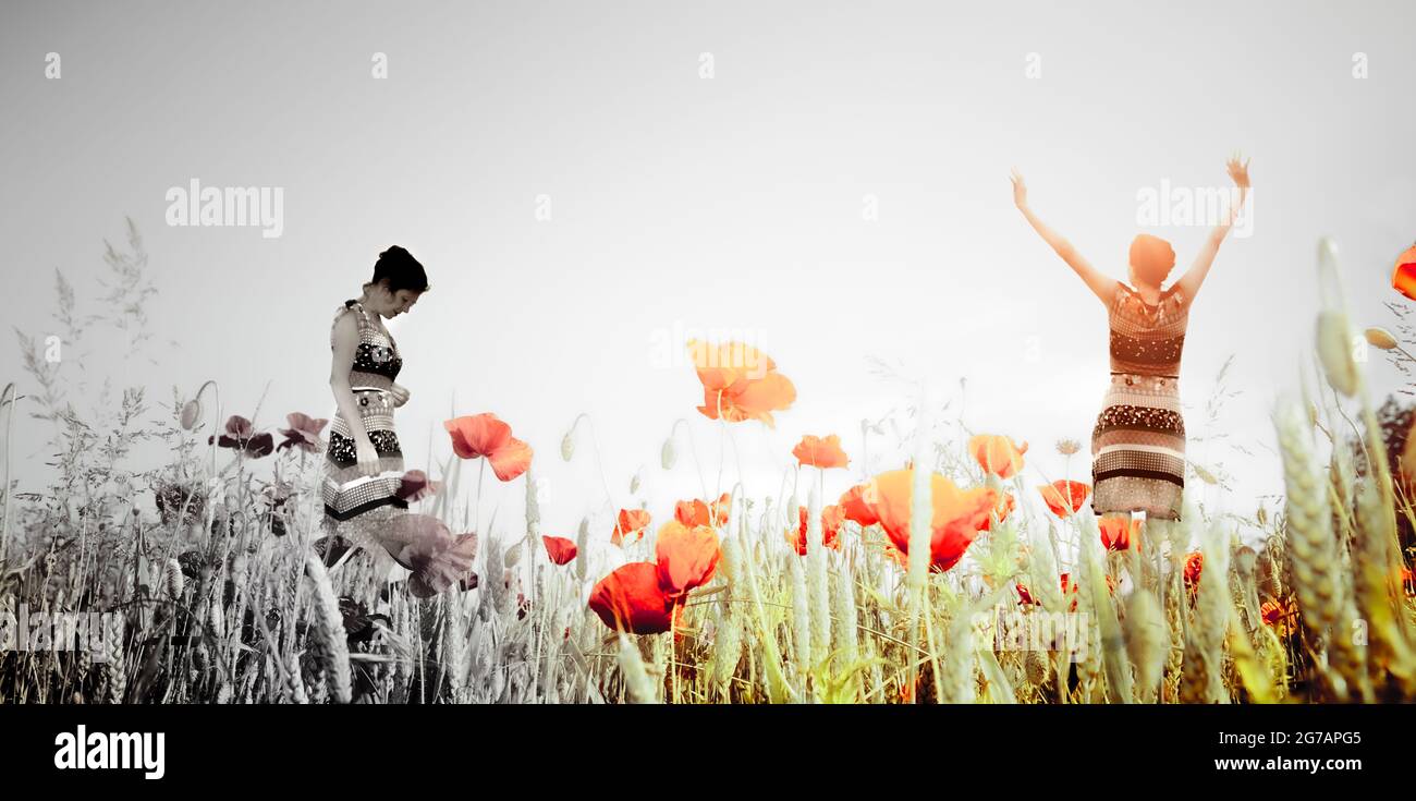 Silhouette of a woman in a poppy field with different emotions as a concept Stock Photo