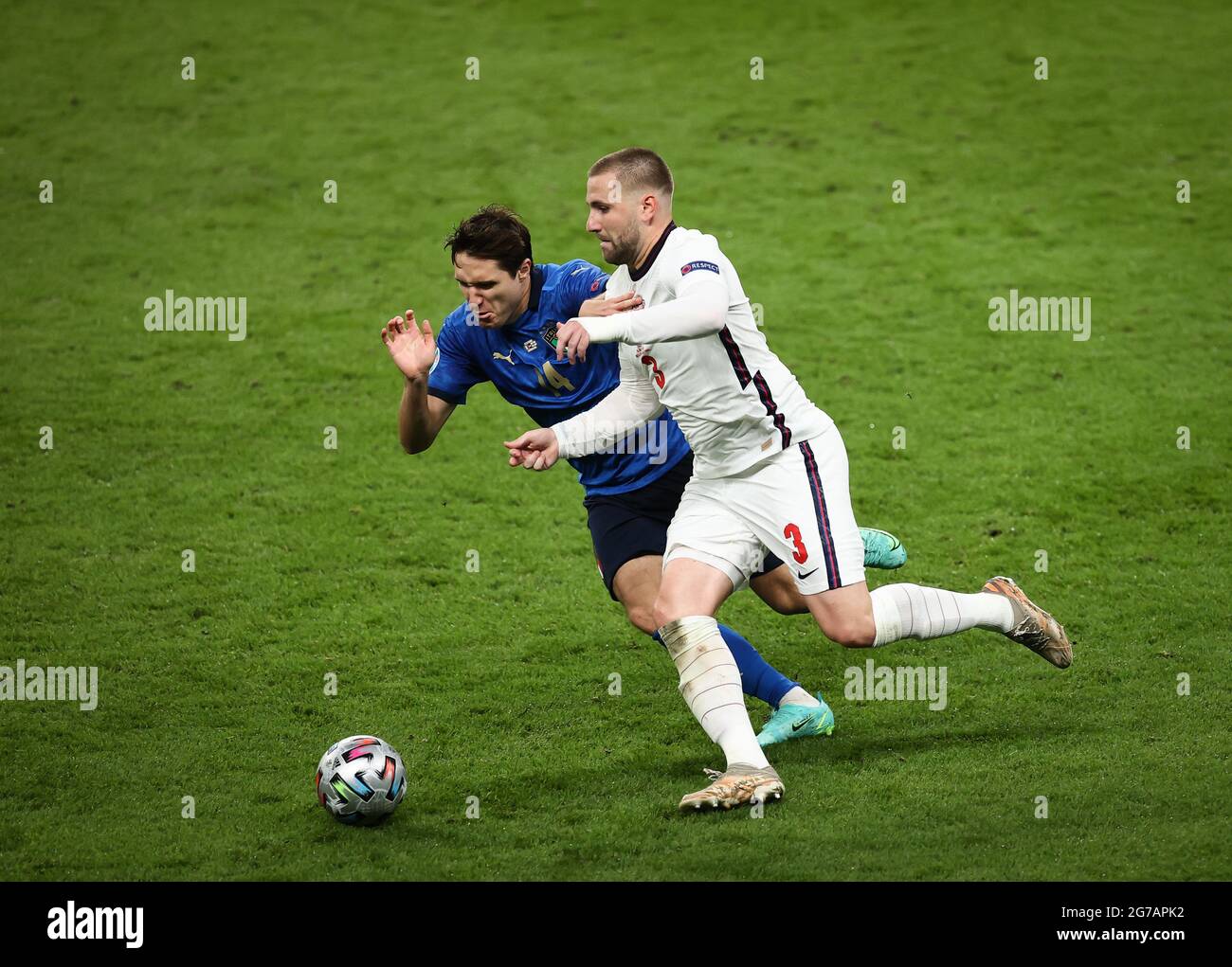 London, UK. 11th July, 2021. Football: European Championship, Italy - England, final round, final at Wembley Stadium. England's Luke Shaw (r) and Italy's Federico Chiesa in action. Credit: Christian Charisius/dpa/Alamy Live News Stock Photo