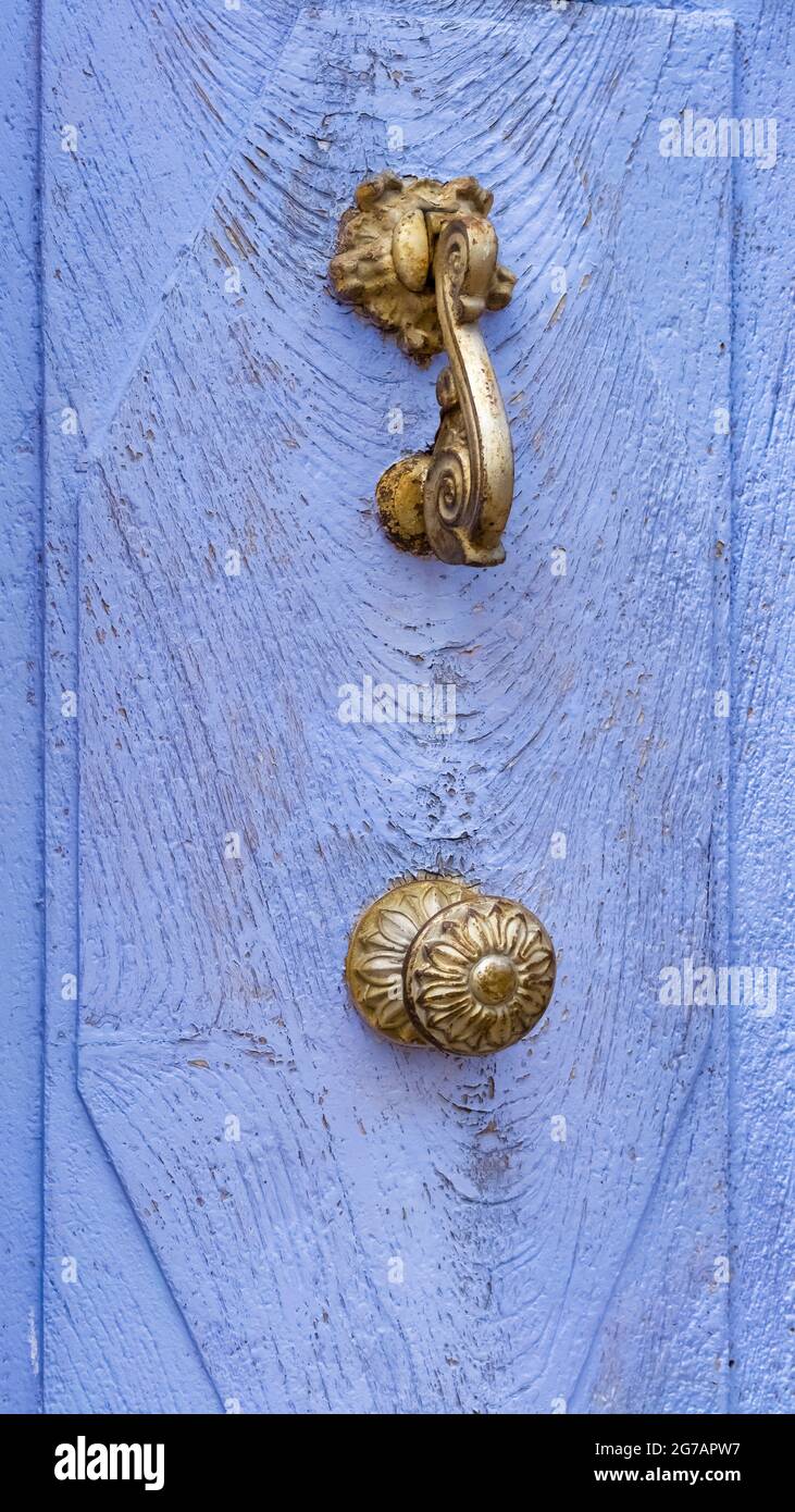 Door knocker and doorknob on door in Palalda near Amélie les Bains. Stock Photo