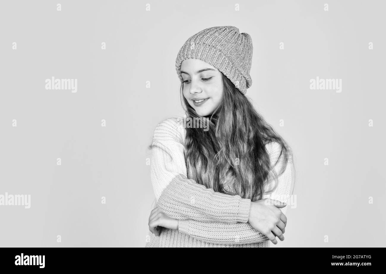 teen girl yellow wall, copy space. little girl in knitwear. kid beauty