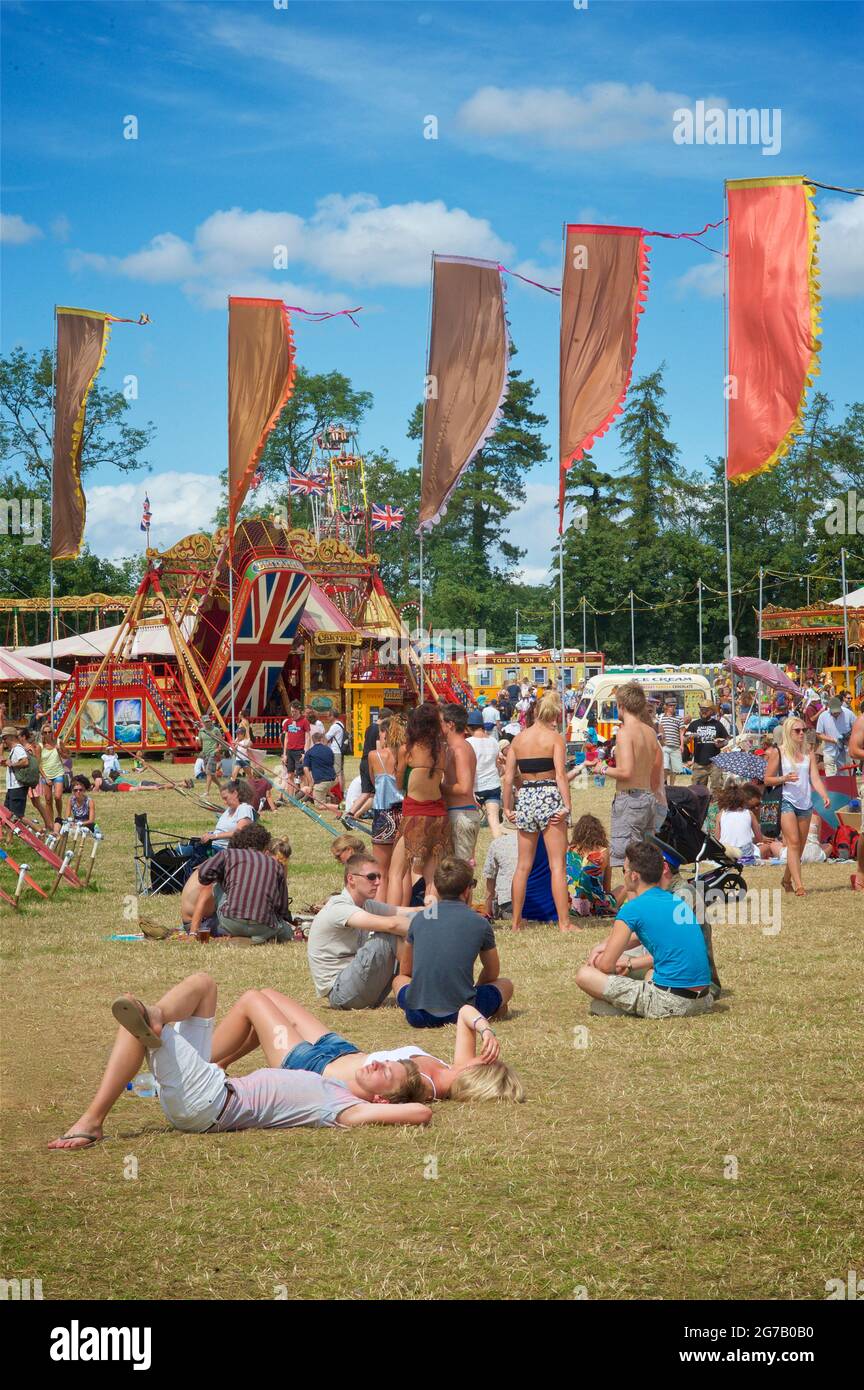 Festivalgoers enjoying the summer sunshine at a gestival in England. Womad festival, Chharlton Park, Malmesbury Wiltshire Stock Photo