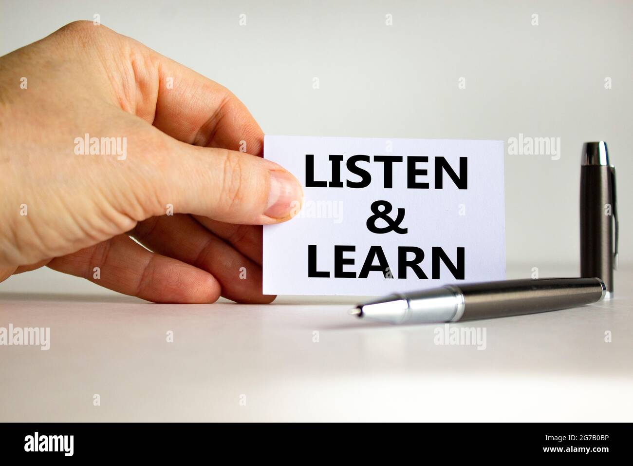 Listen and learn symbol. White paper with words 'Listen and learn' in ...