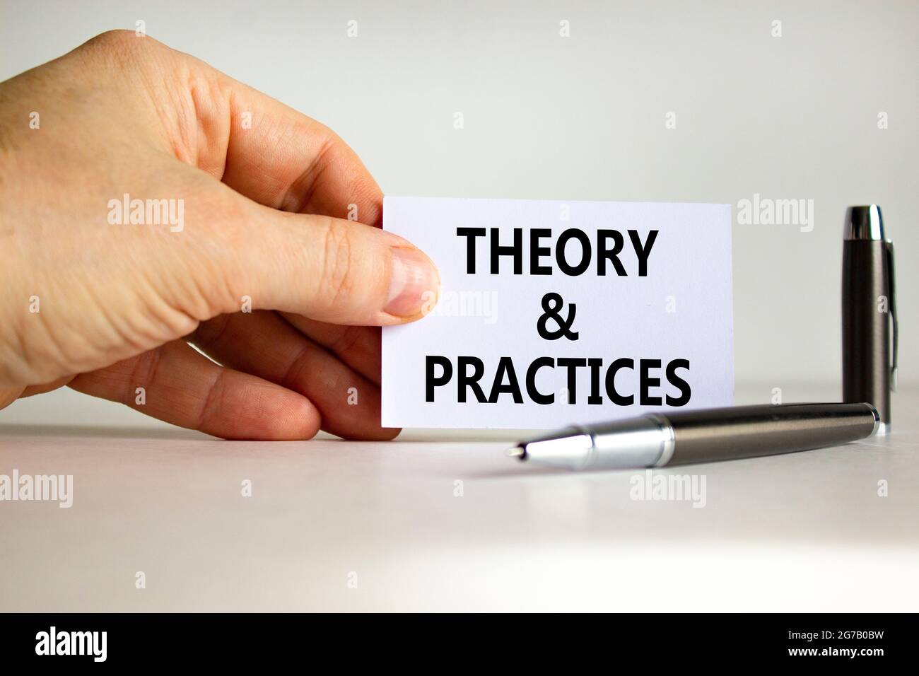 Theory and practice symbol. White paper with words 'Theory and practice ...