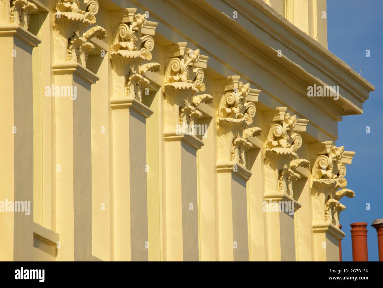Detail of Corinthian column capitals of Brunswick Terrace, part of a complex of elegant Regency houses in Hove on Brighton and Hove seafront. East Sussex England UK Stock Photo