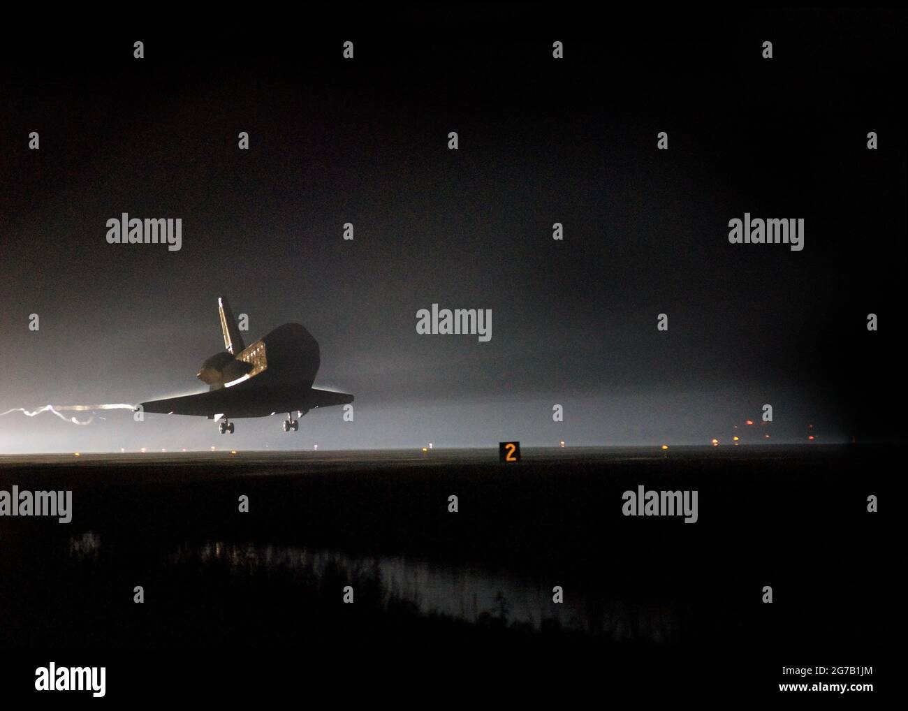Space Shuttle Endeavour Touchdown STS-123. As night falls on NASA's Kennedy Space Center, Space Shuttle Endeavour is moments away from touchdown on Runway 15 at the Shuttle Landing Facility to end the STS-123 mission, a 16-day flight to the International Space Station.  The mission completed nearly 6.6 million miles.The landing was on the second opportunity after the first was waved off due to unstable weather in the Kennedy Space Center area.   A unique optimised and enhanced version of an NASA image / mandatoty credit: NASA Stock Photo
