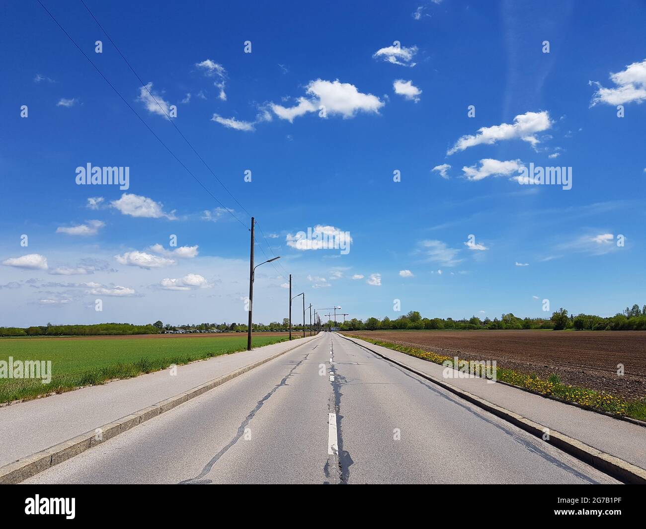 Blue sky with clouds and country road Stock Photo