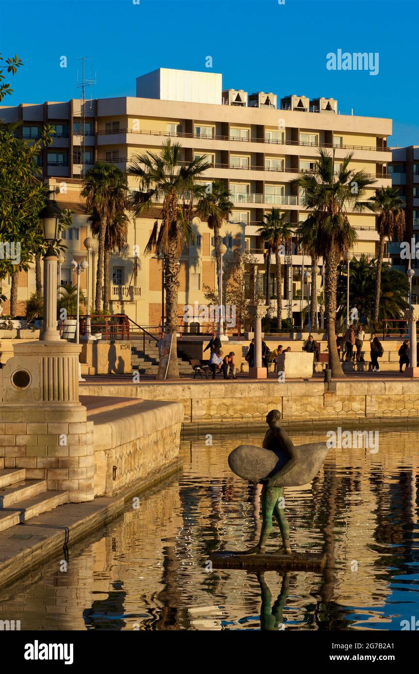 Bronze statue in the waters of the inner dock of the port, a few meters from the stairs of the Plaza de Tomás y Valiente in Alicante. Entitled 'El regreso de Icaro con su ala de surf' -'The return of Icarus with his surfing wing'.  by Esperanza d'Ors; instaled 1999. Stock Photo