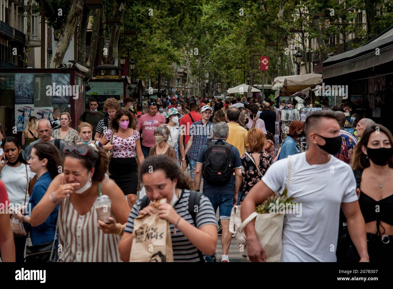 Barcelona, Spain. July 12, 2021, Barcelona, Spain: People, much of them  tourists, crowd La Rambla in Barcelona. Spain is among EU countries with  highest coronavirus infection rates, some regions are reimposing measures