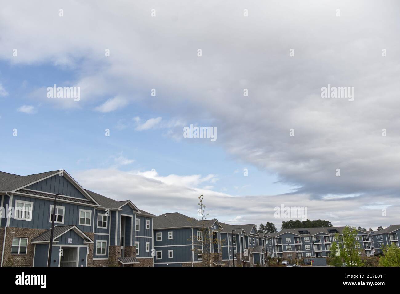 Augusta, Ga USA 03 30 21 Rows of modern apartment buildings with blue sky with clouds Stock