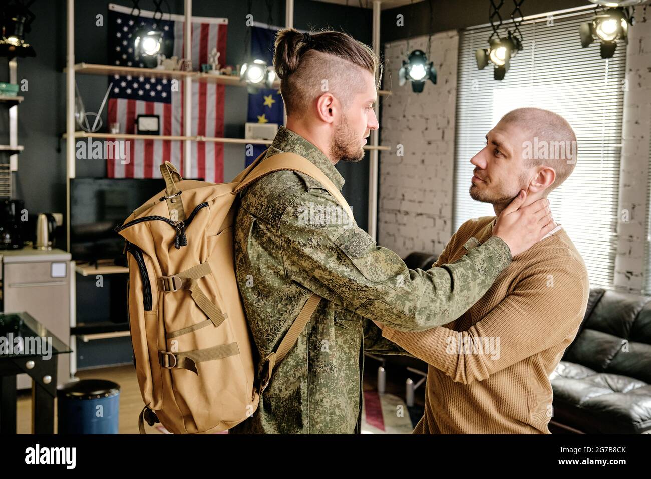 Happy handsome young man meeting his husband coming back home after military exercises Stock Photo
