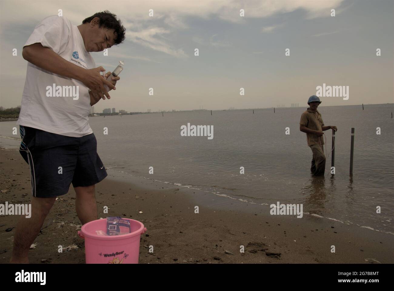 East Ancol, Jakarta, Indonesia. 2nd June 2009. Scientists from the Indonesian Institute of Sciences (LIPI) are working with research instruments on the beach, which is a part of a series of their research activities to find out, among others, how far the sea water infiltration has impacted the groundwater source quality in the city of Jakarta, Indonesia. Jakarta has been suffering from land subsidence, sea water infiltration and floods. Stock Photo