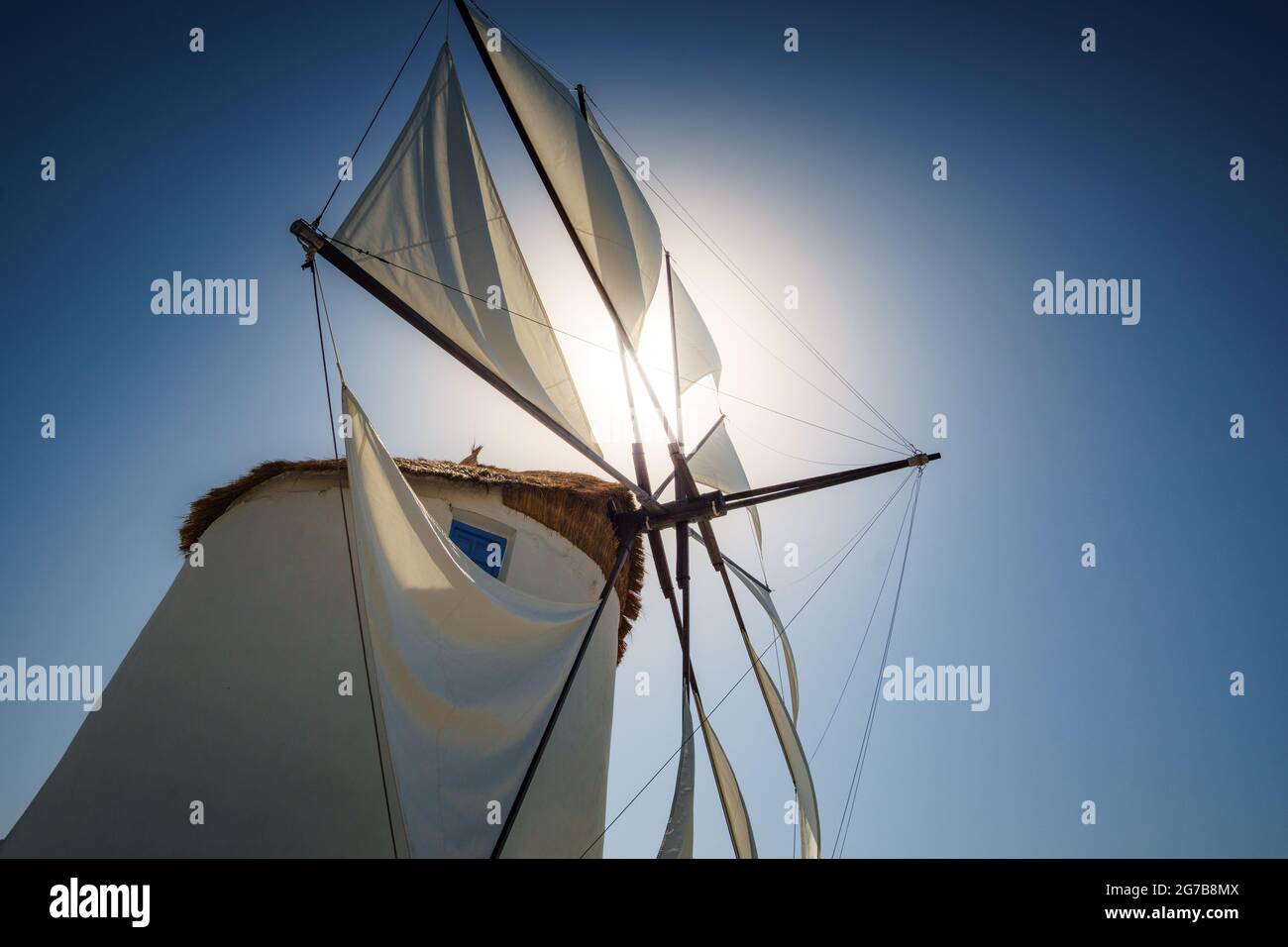 Traditional cycladic windmill against a deep blue sky in a beautiful summer day on Paros island, Cyclades, Greece Stock Photo