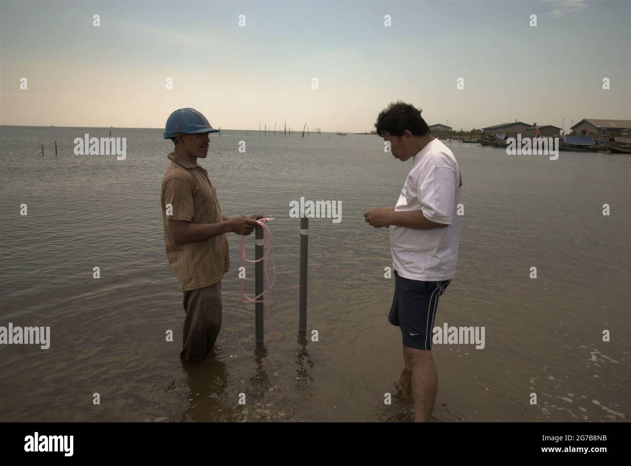 East Ancol, Jakarta, Indonesia. 2nd June 2009. Scientists from the Indonesian Institute of Sciences (LIPI) are working with research instruments on the beach, which is a part of a series of their research activities to find out, among others, how far the sea water infiltration has impacted the groundwater source quality in the city of Jakarta, Indonesia. Jakarta has been suffering from land subsidence, sea water infiltration and floods. Stock Photo