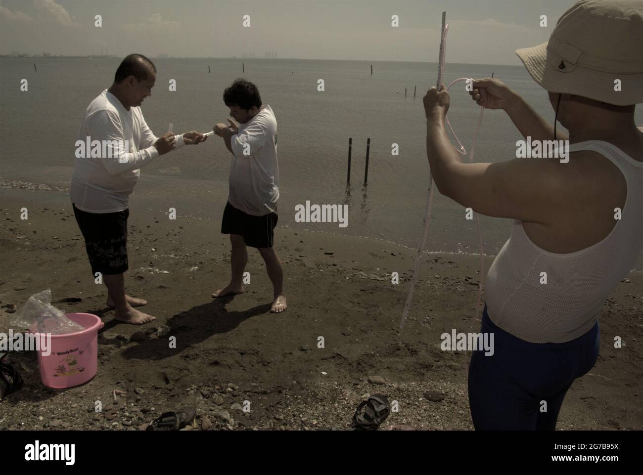 East Ancol, Jakarta, Indonesia. 2nd June 2009. Scientists from the Indonesian Institute of Sciences (LIPI) are working with research instruments on the beach, which is a part of a series of their research activities to find out, among others, how far the sea water infiltration has impacted the groundwater source quality in the city of Jakarta, Indonesia. Jakarta has been suffering from land subsidence, sea water infiltration and floods. Stock Photo