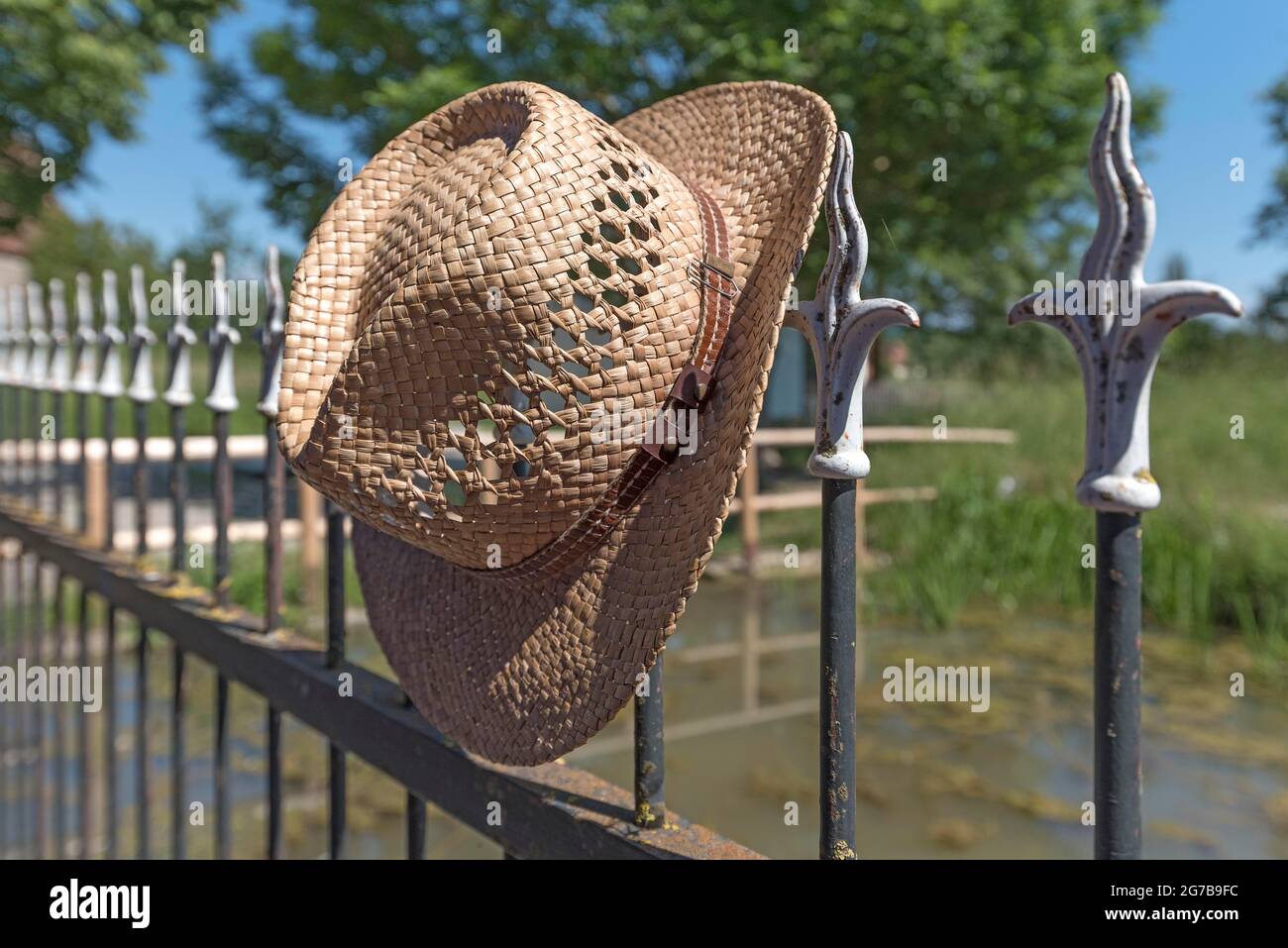Straw hat on an old picket fence, Franconian Open Air Museum, Bad Windsheim, Middle Franconia, Bavaria, Germany Stock Photo