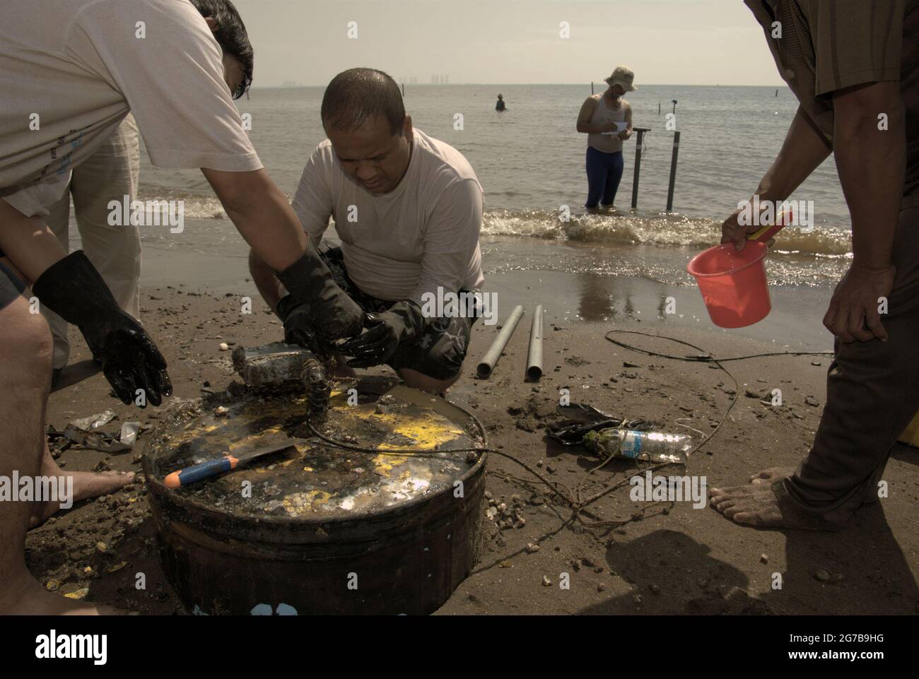 East Ancol, Jakarta, Indonesia. 2nd June 2009. Scientists from the Indonesian Institute of Sciences (LIPI) are working with research instruments on the beach, which is a part of a series of their research activities to find out, among others, how far the sea water infiltration has impacted the groundwater source quality in the city of Jakarta, Indonesia. Jakarta has been suffering from land subsidence, sea water infiltration and floods. Stock Photo