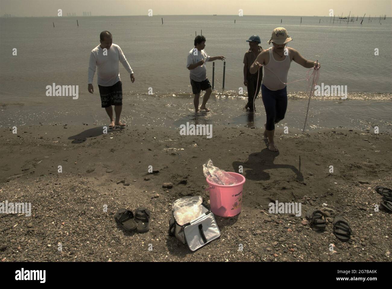 East Ancol, Jakarta, Indonesia. 2nd June 2009. Scientists from the Indonesian Institute of Sciences (LIPI) are working with research instruments on the beach, which is a part of a series of their research activities to find out, among others, how far the sea water infiltration has impacted the groundwater source quality in the city of Jakarta, Indonesia. Jakarta has been suffering from land subsidence, sea water infiltration and floods. Stock Photo