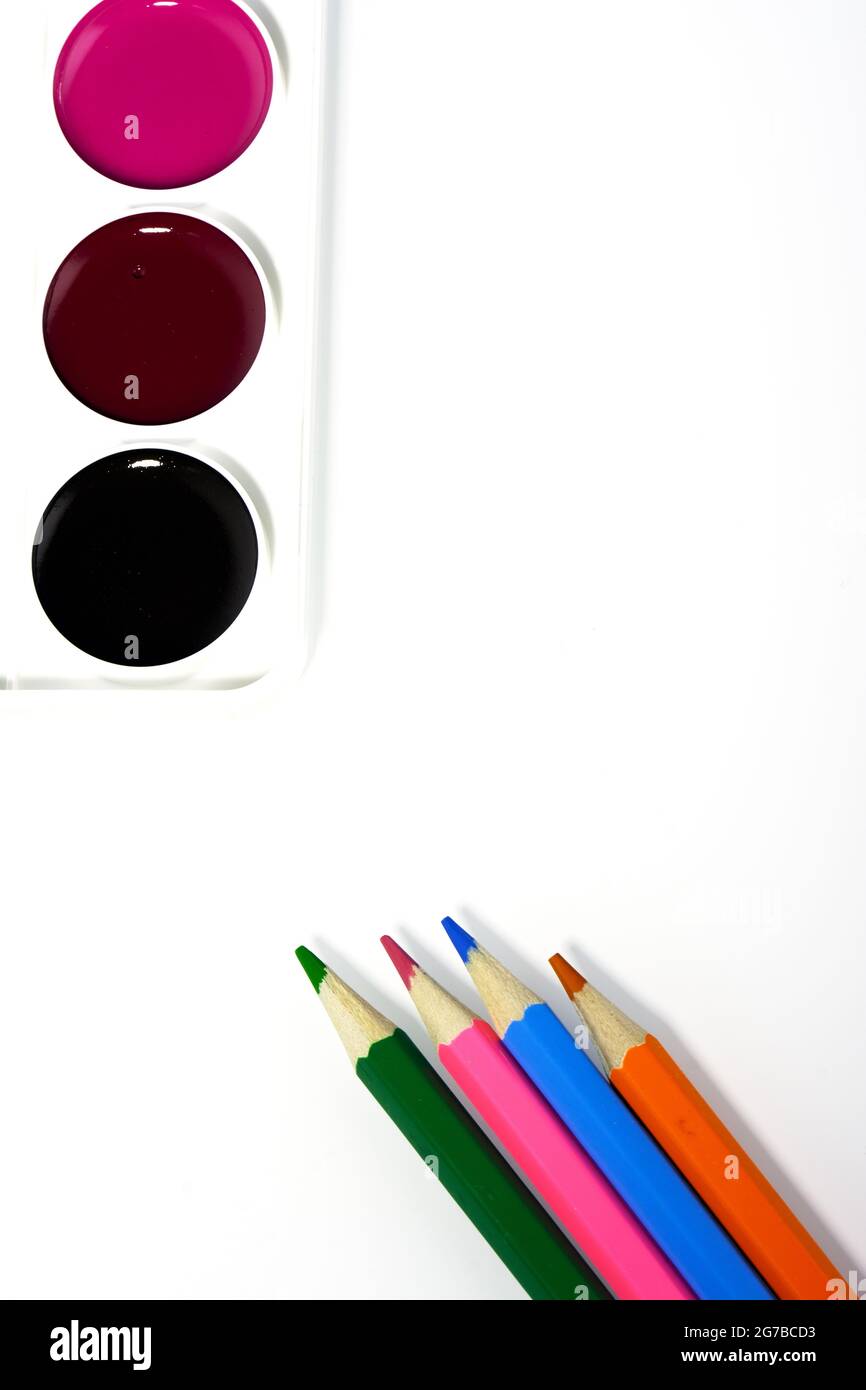 Pencils and watercolors, on a white background, top view Stock Photo