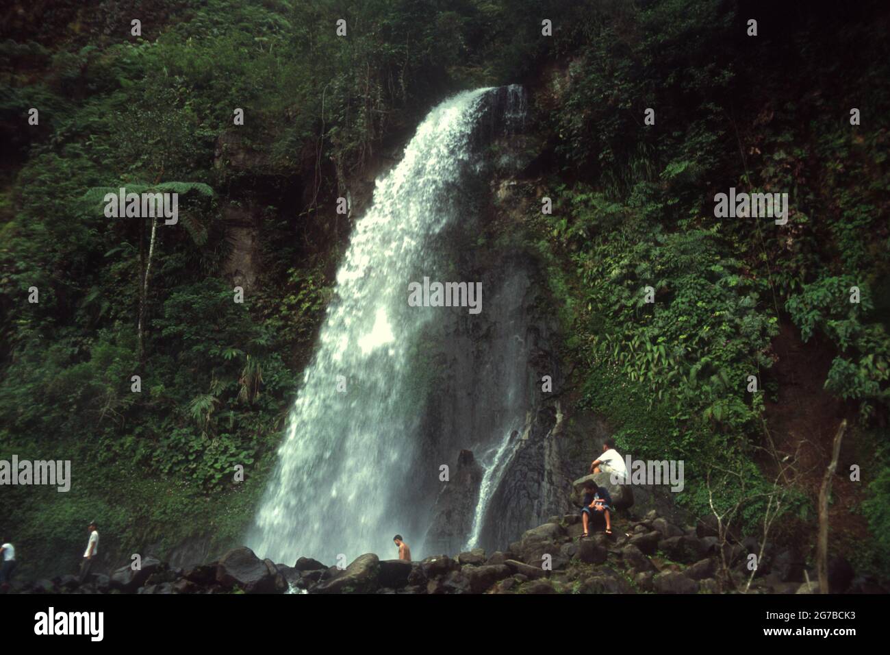 People having a recreational time at Cibeureum waterfall in Mount Gede Pangrango National Park, West Java, Indonesia. Stock Photo