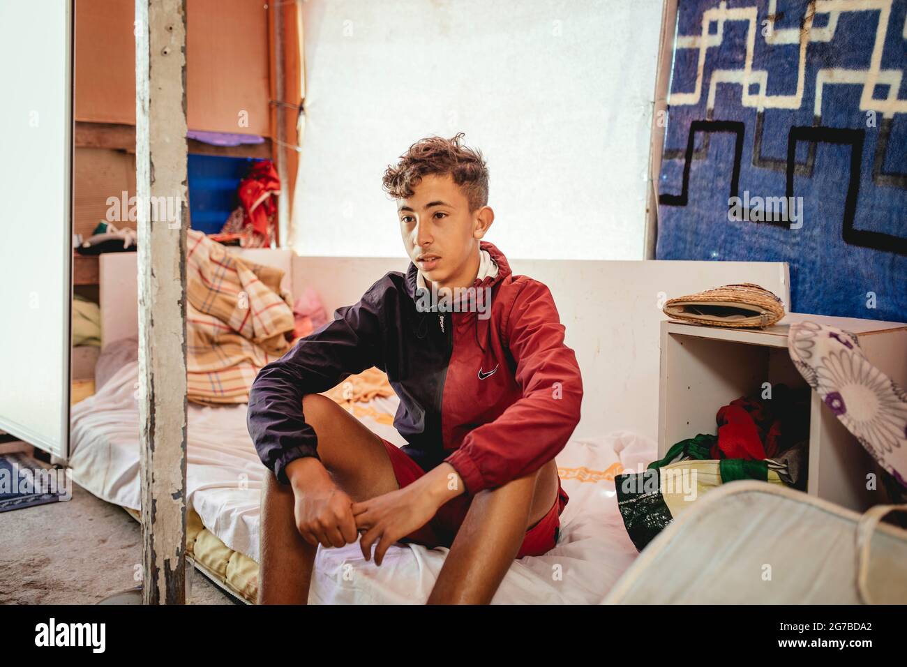 Ayoub, 16, from Tetouan, arrived in Ceuta by water one and a half months ago, lives in a makeshift shelter on the cliff, Recinto Sur, Ceuta, Spain Stock Photo