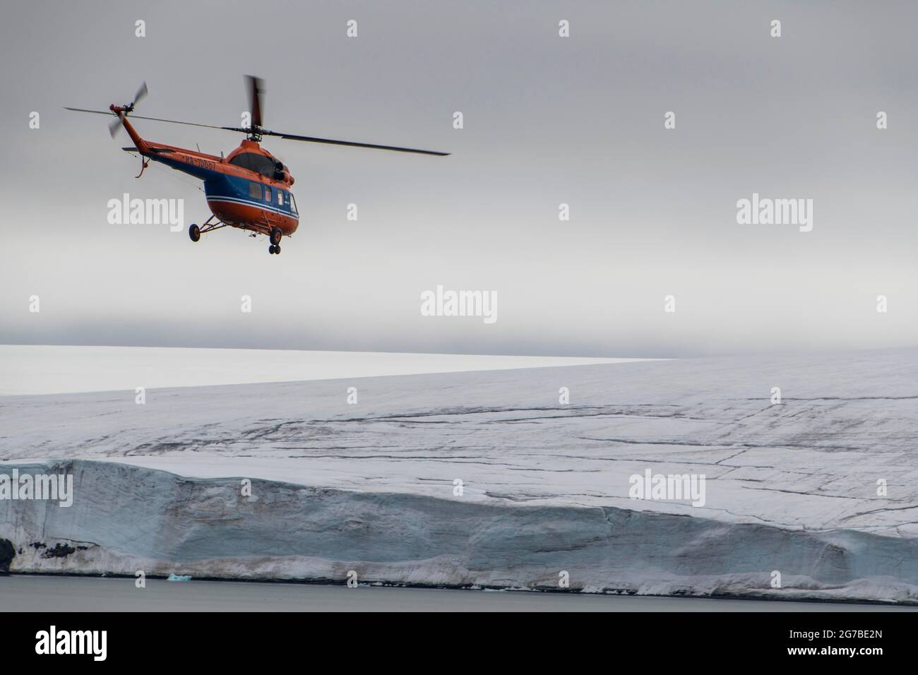 Helicopter flying over the giant icefield of Alexandra Land, Franz Josef Land archipelago
