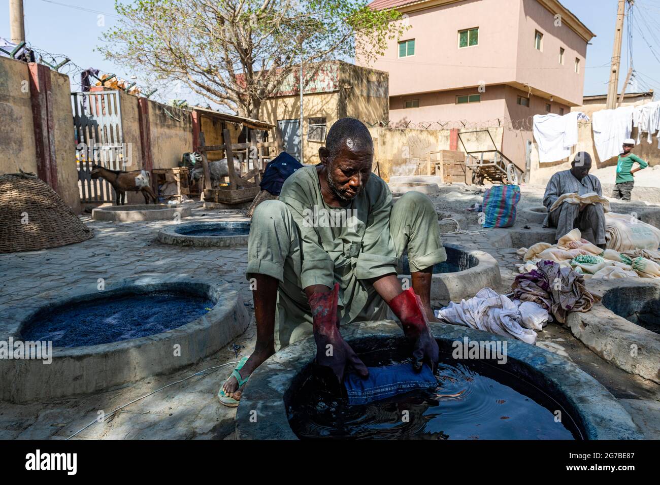 Man dyeing cllothes with Indigo, Dyeing pits, Kano, Kano state, Nigeria Stock Photo