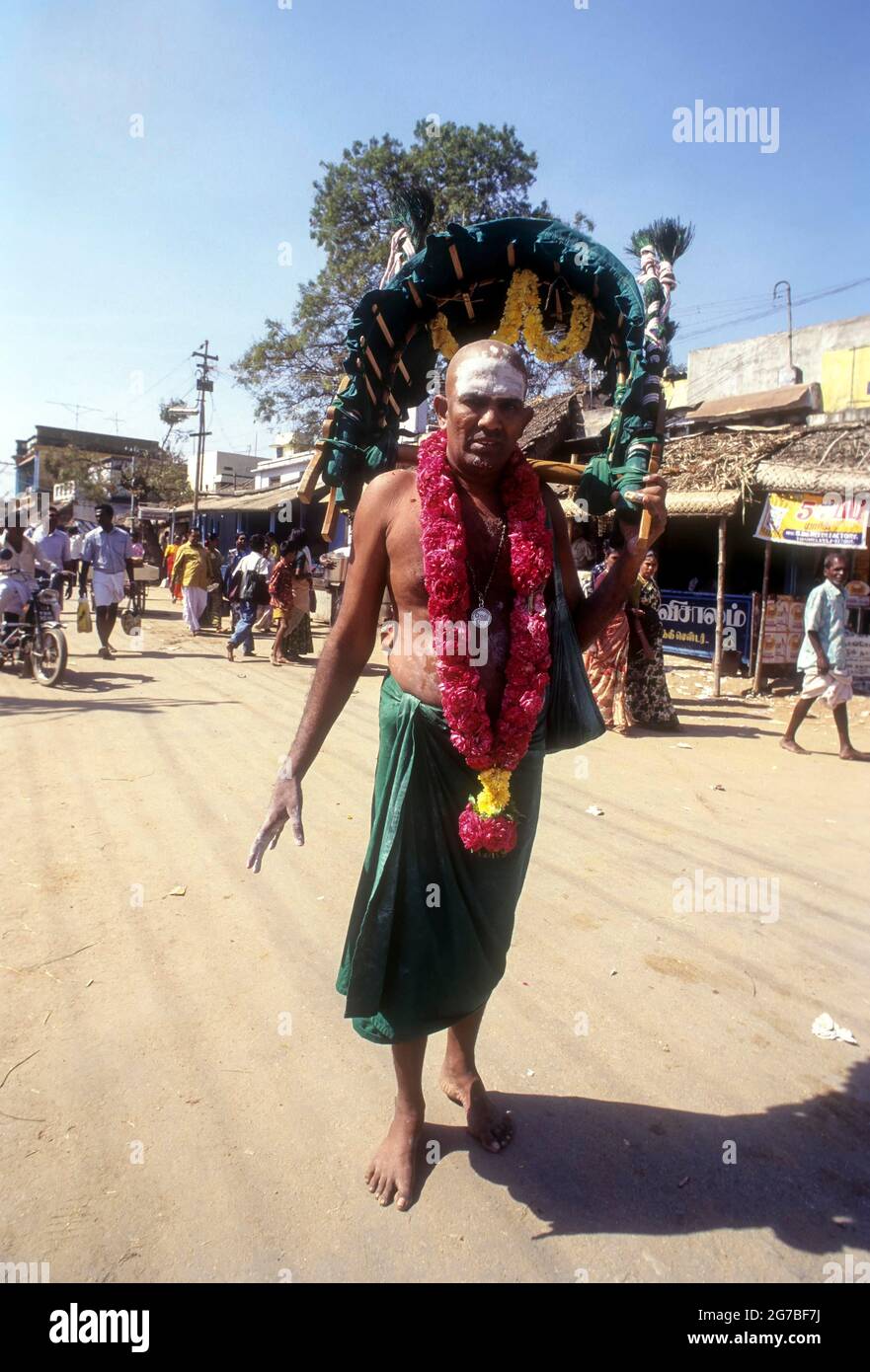 A sadhu carrying Kavadi on his shoulder to Palani on Thai Poosam day