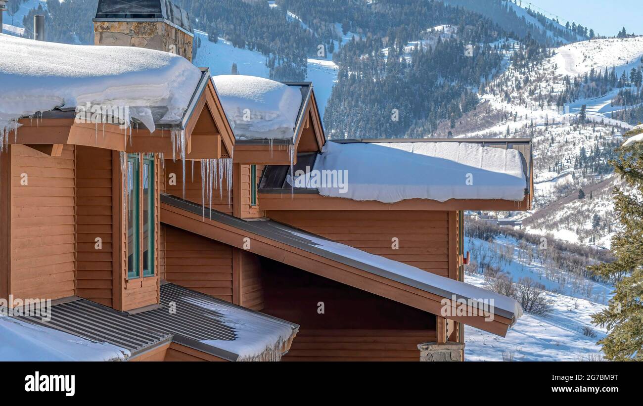 Pano House with snow and icicles against Park City Utah mountain on a ...
